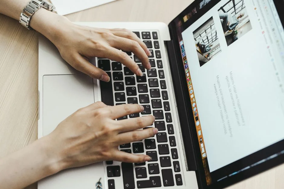 our-story Person analyzes stock data with a smartphone and laptop, indoors.